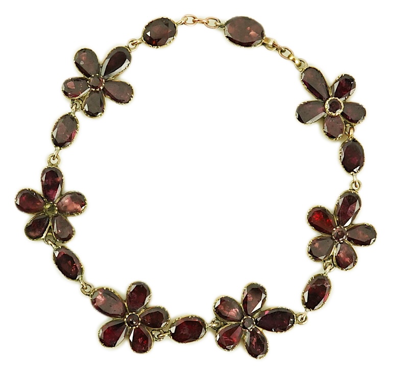 An early Victorian gold and foil backed garnet cluster set bracelet